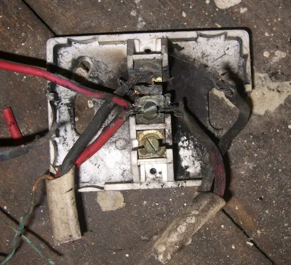 Overheated junction box with signs of electrical arcing Burnt junction box showing electrical arcing under floor in Banbury