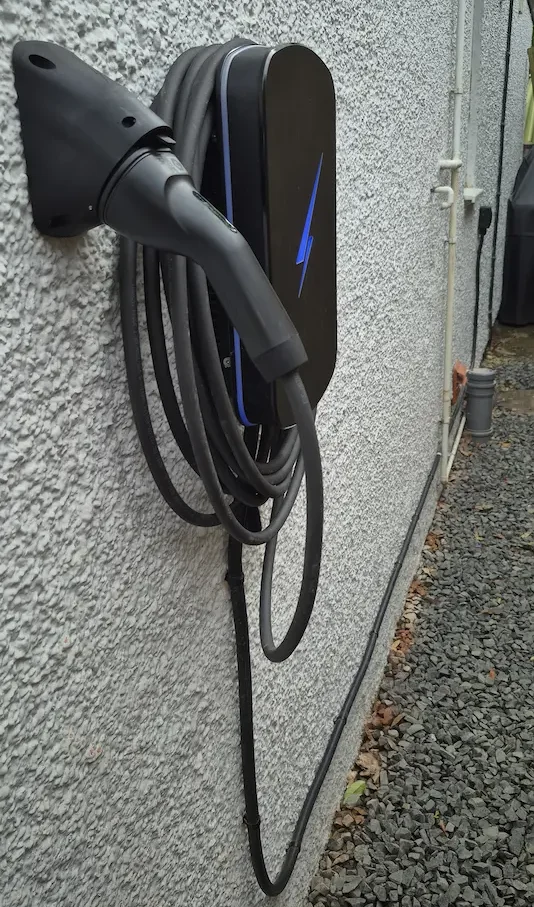 A home EV charger installation with the cable routed externally to keep the wiring neat and practical. Home EV charger installed with external cable route in Adderbury