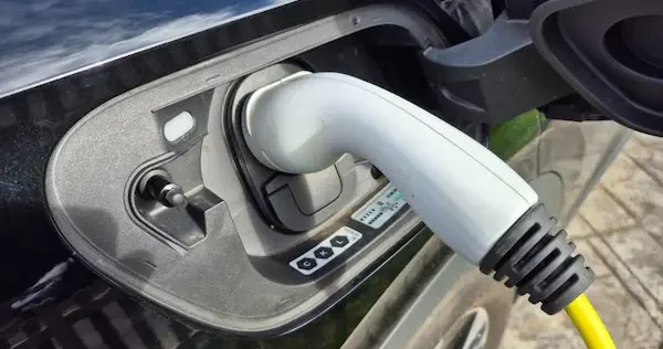 Most home EV chargers in the UK charge at around 7kW, although the actual charging speed depends on the car, charger and property supply. Electric car plugged in and charging at home
