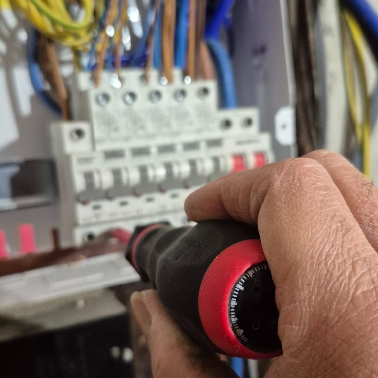 Tightening connections with torque screwdriver during consumer unit installation in Banbury