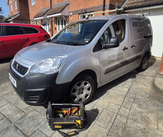 How to Choose a good Electrician RW Currion Electrical van outside a house in Banbury
