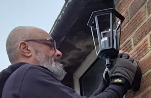 Electrician installing outdoor wall light in Banbury