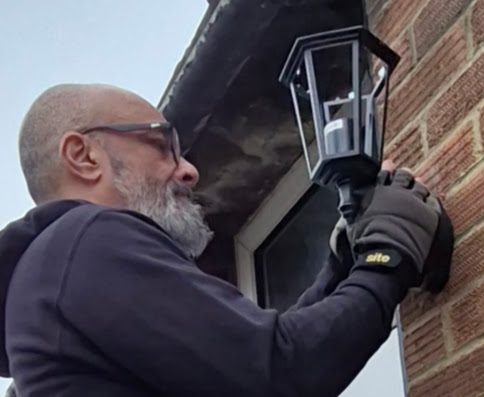 Richard Currion carrying out an outdoor lighting installation