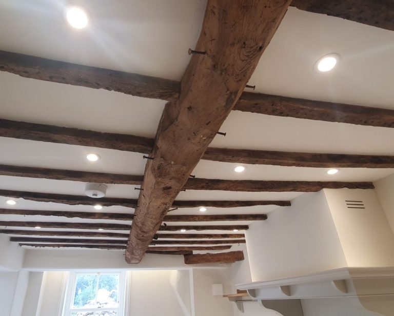 Modern LED downlights fitted in ceiling with exposed beams in Banbury home