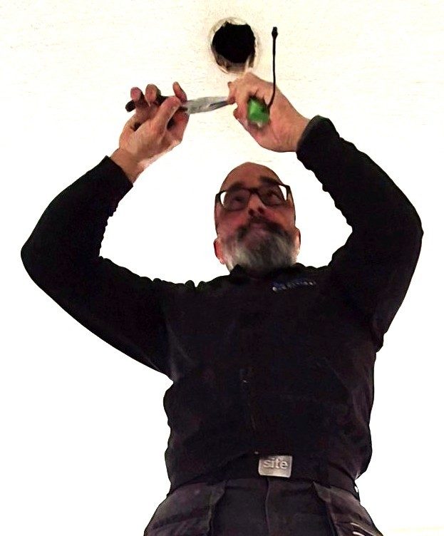 Electrician in Banbury installing ceiling lighting