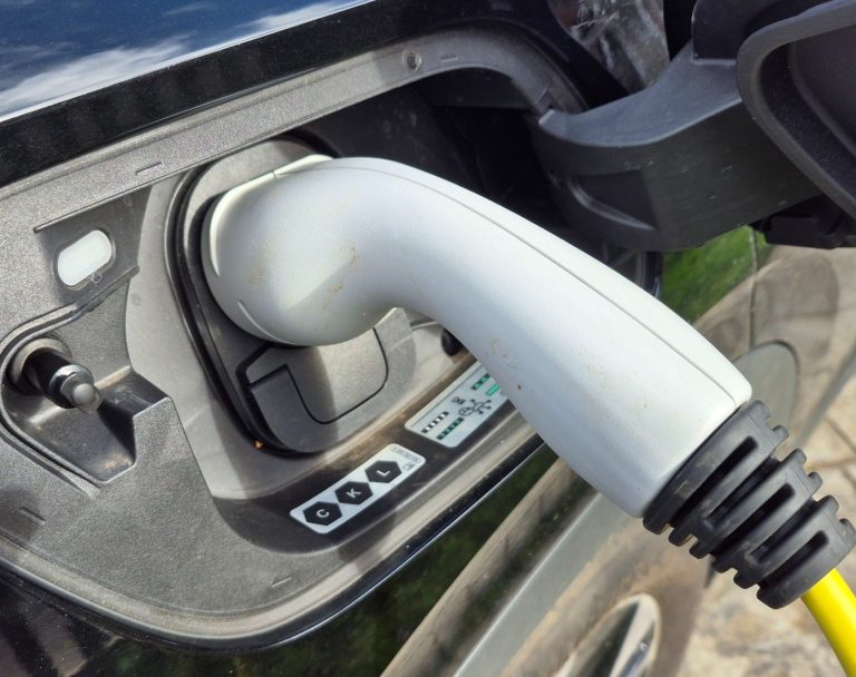 Learn about our EV charger services EV charging socket connected to electric vehicle